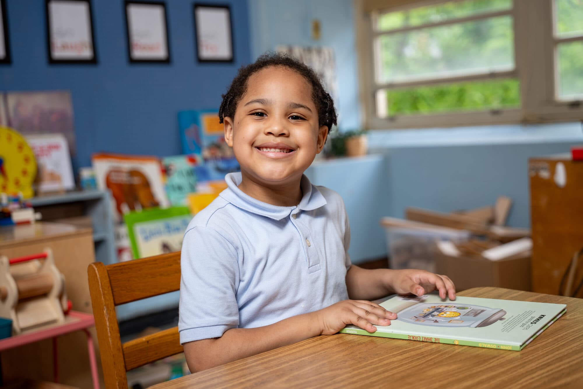 An FLI student reading at her desk.